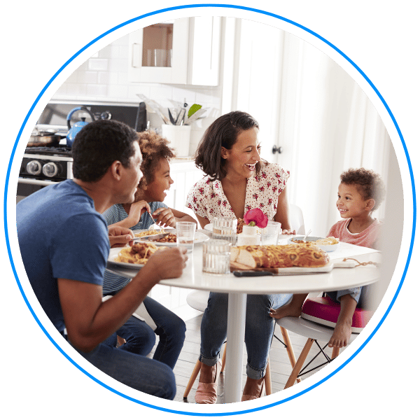 family laughing and smiling at dinner table