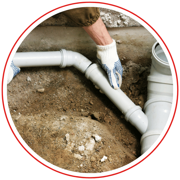 plumber fits drain pipe in crawl space