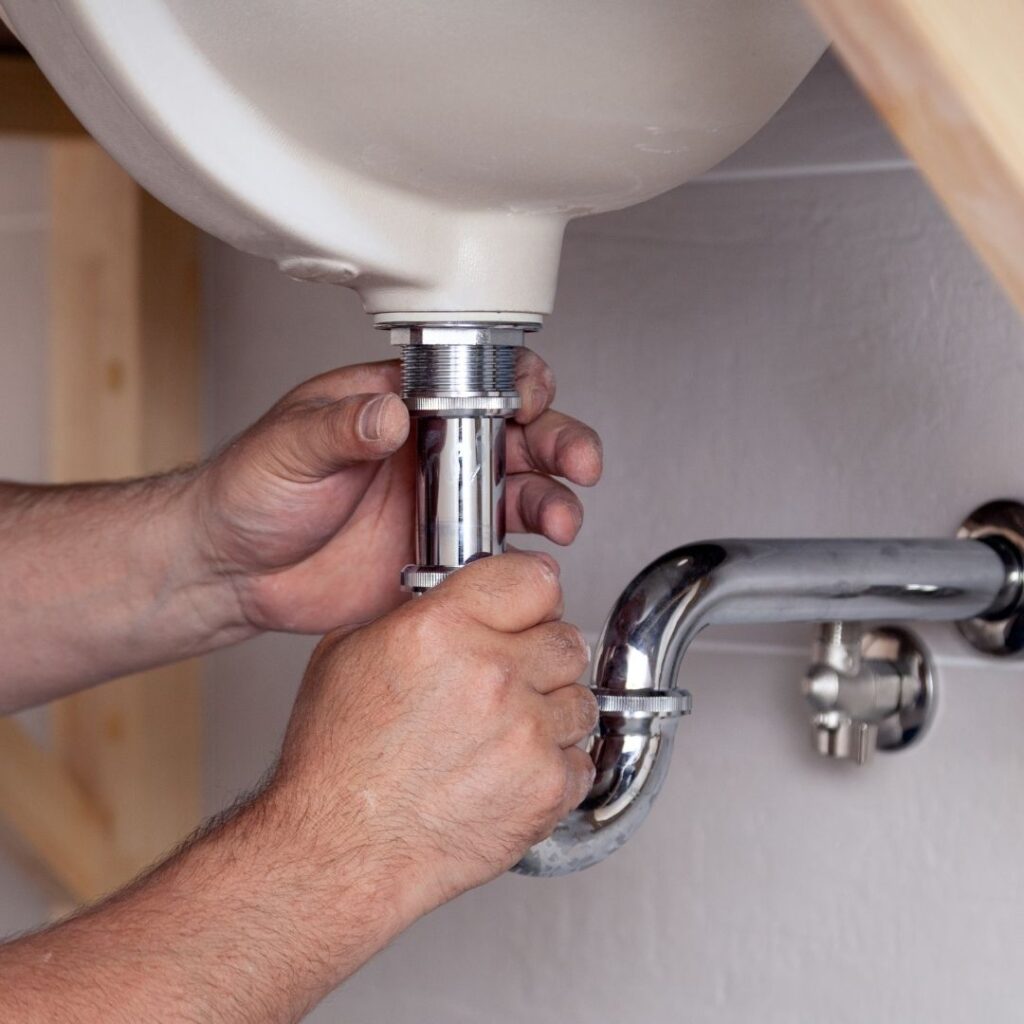 plumber adjusting pipe